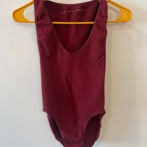 Out from under red body suit